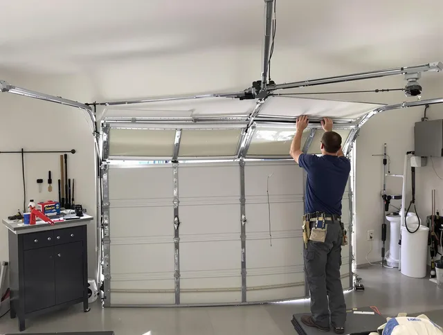 Duxbury Garage Door Repair specialist performing precise section replacement on Duxbury garage door
